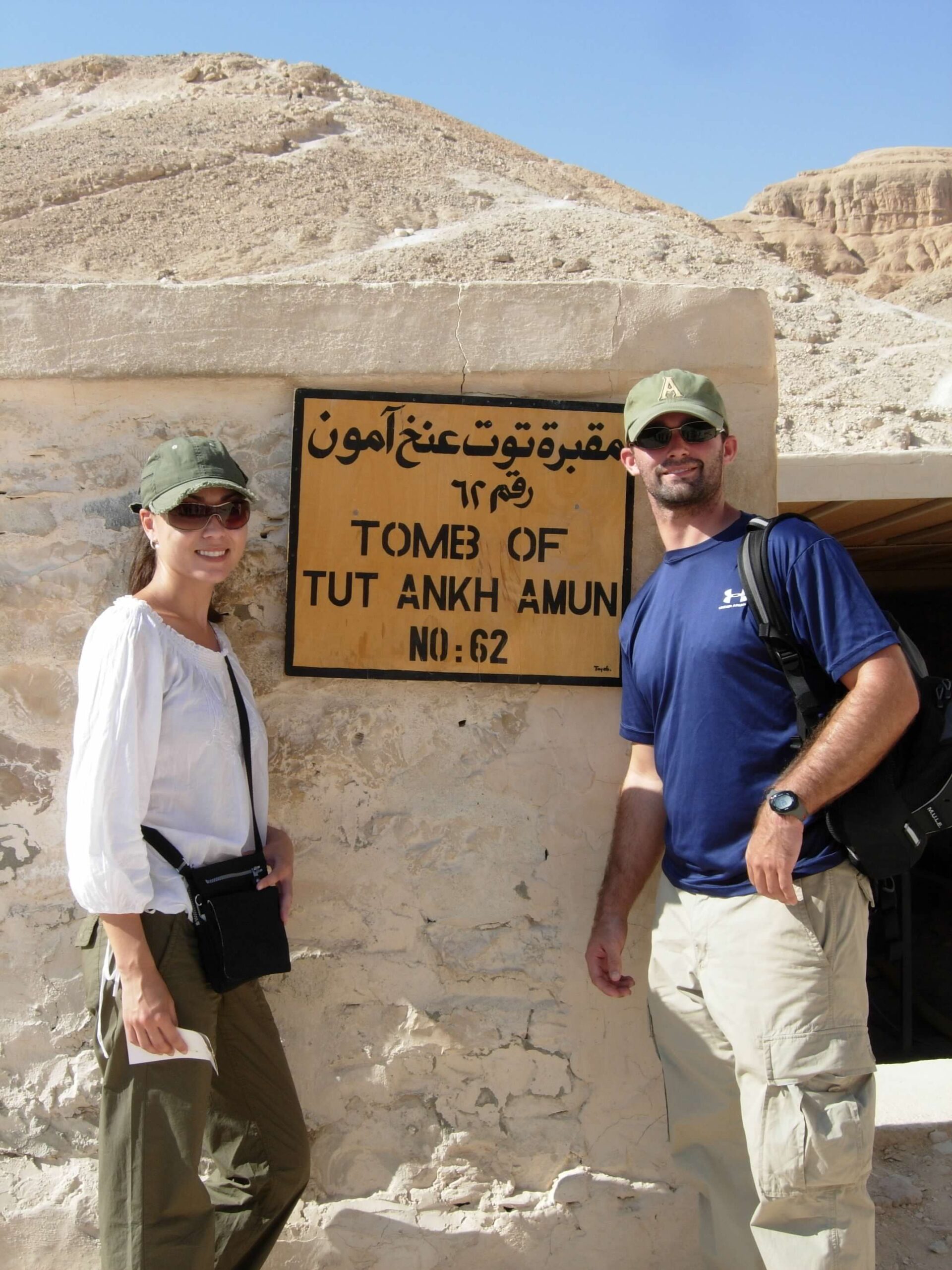 man and woman in front of the tomb of tut ankh amun in Egypt