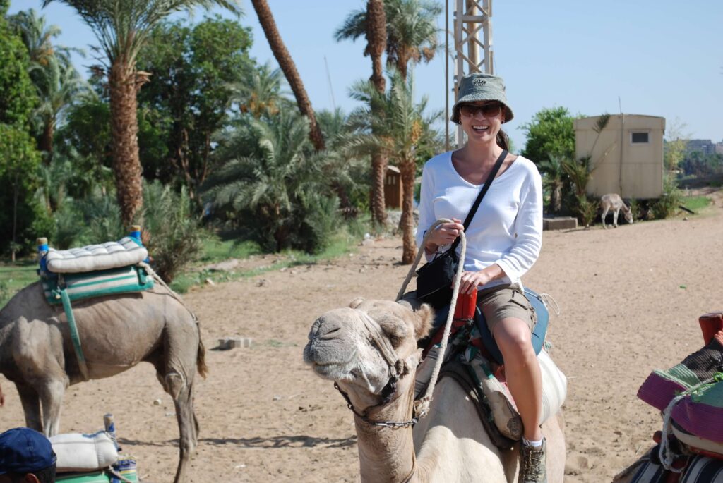 woman on camel in Egypt dessert