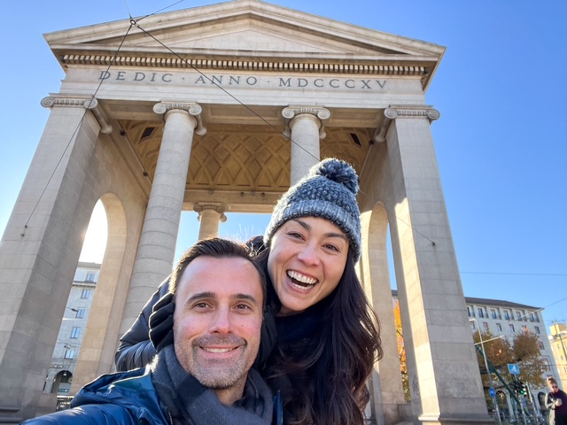 man and woman in front of Roman style building in Milan